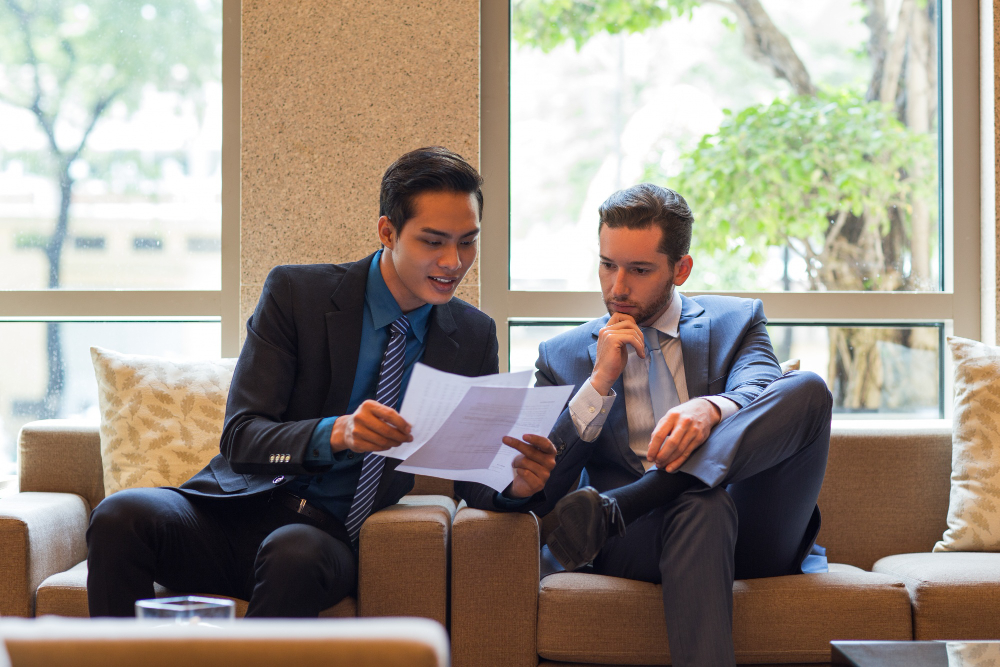 Two business professionals reviewing documents together