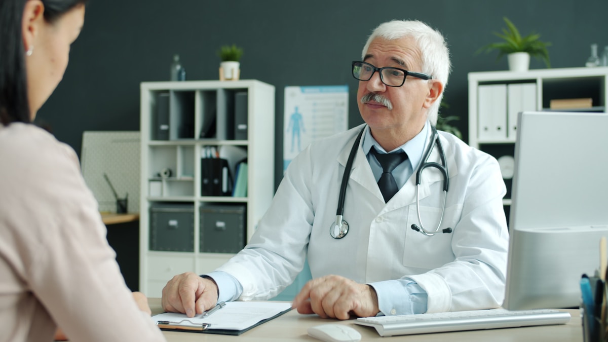 Medical professional speaking with a patient during a consultation