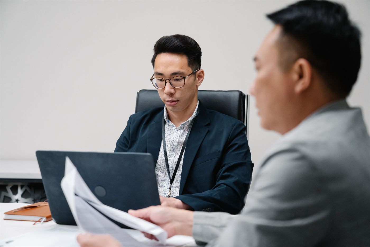 Two professionals reviewing documents during a focused advisory meeting