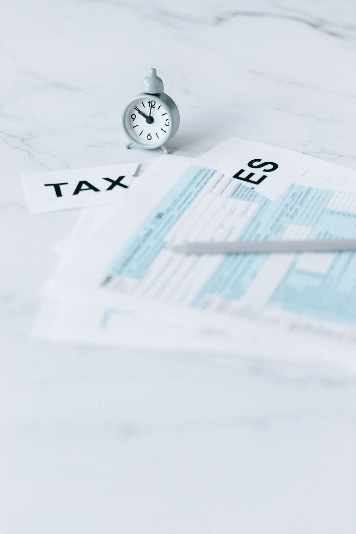 Tax forms and a clock representing filing deadlines and planning